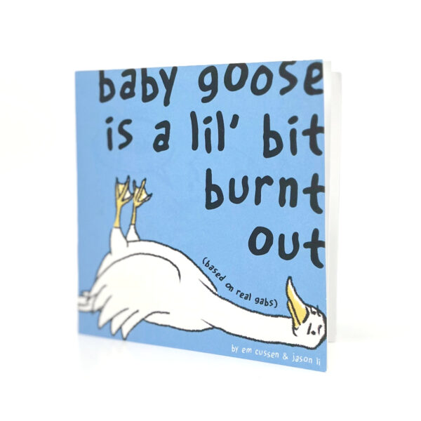 A zine stands on a white background. The zine is titled baby goose is a lil' bit burnt out. then there's a white goose lying down on the floor, set on top of a blue background. a small bit of text on its neck says "(based on real gabs)"